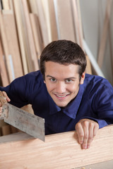 Happy guy using a saw