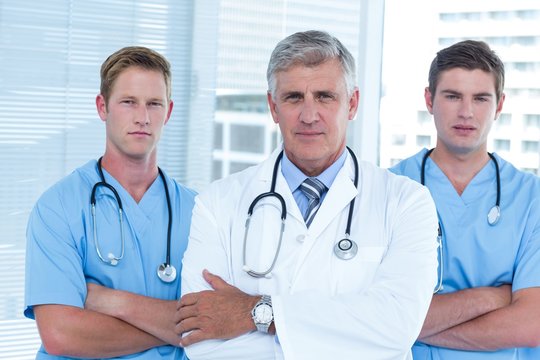 Team of doctors standing arms crossed