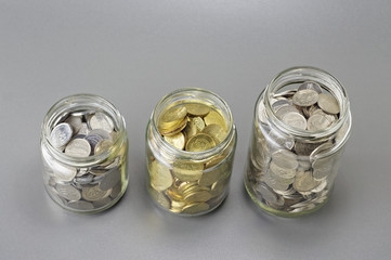 Coins in The Three Different Size of Jar - Financial Concept