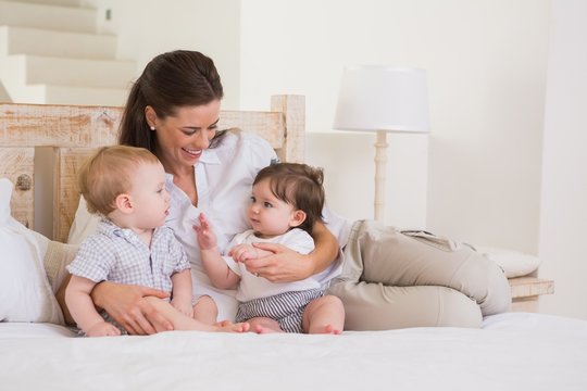 Happy mother with cute babies boy and girl