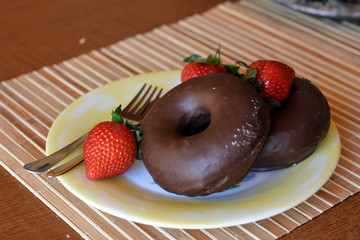 Homemade Donuts With Fresh Strawberries On A Plate On A Table