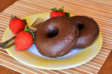 Homemade Donuts With Fresh Strawberries On A Plate On A Table