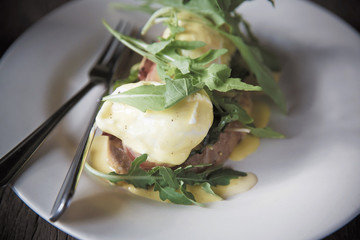 egg benedict on wood background