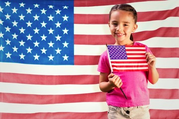 Composite image of little girl with american flag