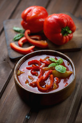 Wooden bowl with hungarian lecho, studio shot, selective focus
