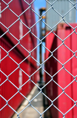 Fototapeta premium Wire mesh fence enclosing the container yard