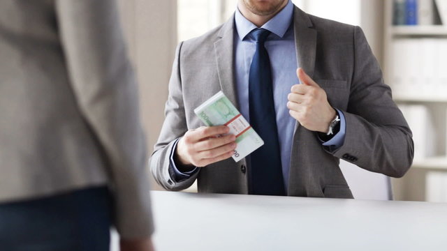close up of businessman taking money bribe