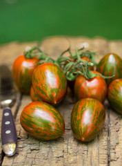 Tiger striped tomatoes on an old wooden table