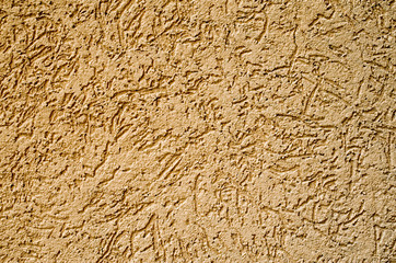 Decorative dark yellow relief plaster on wall