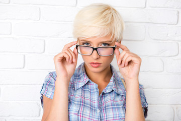 sexy girl adjusts her glasses