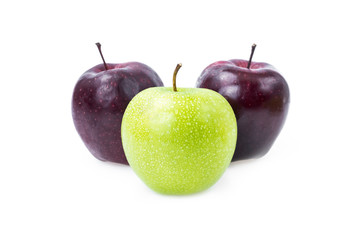 Green apple with water drops and red apple on white background.
