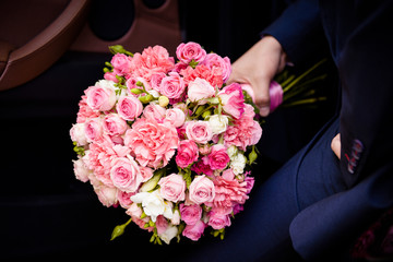 Big roses bouquet in men hand