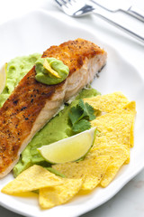 grilled salmon fillet with avocado sauce and nachos