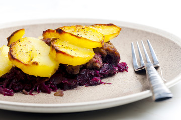 potatoes baked with pork minced meat and red cabbage