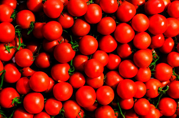 Red Cherry tomatoes in market close up, may use as background. .