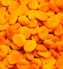 Heap of dried apricots background close-up. Food healthy backdro