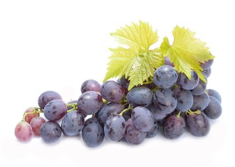 Red grapes with leaves isolated on white background