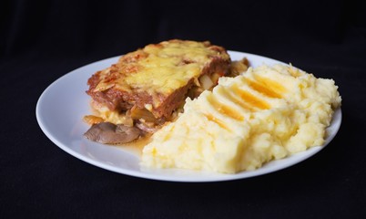 mashed potatoes chicken pocket stuffed with chopped vegetables dark background