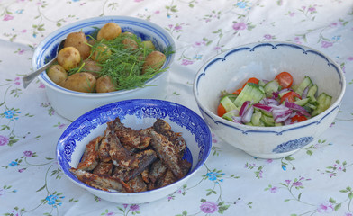 Three bowles with herring, potato and sallad