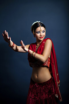 Beautiful young dancing woman in traditional indian clothing