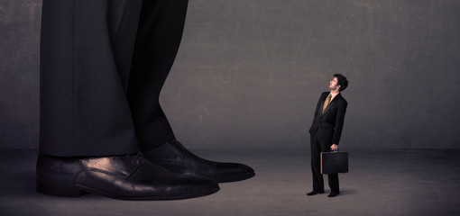 Huge legs with small businessman standing in front concept