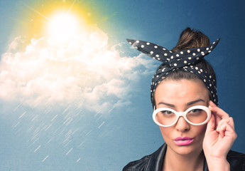 Young person looking with sunglasses at clouds and sun