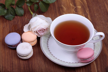 Cup of tea with colorful french macaron