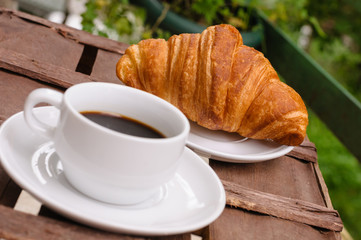 cup of coffee with croissant