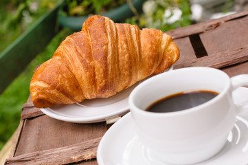 cup of coffee with croissant