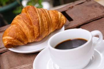 cup of coffee with croissant