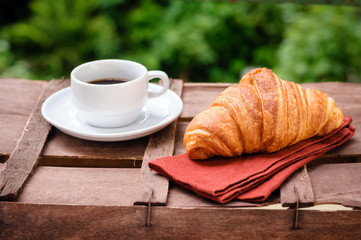 cup of coffee with croissant