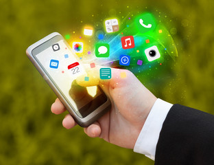 Hand holding smartphone with colorful app icons