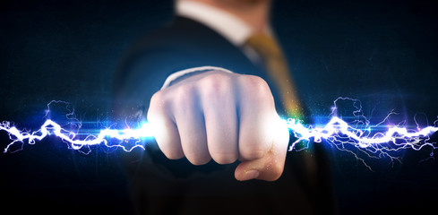 Business man holding electricity light bolt in his hands