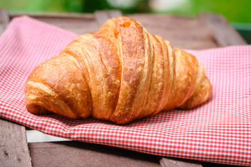 croissant on brown wood table