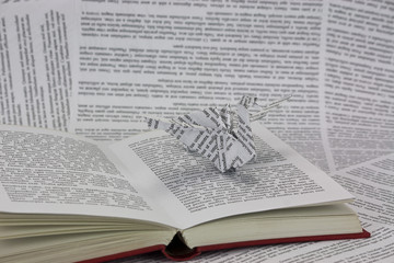 Origami dragon coming out of a book