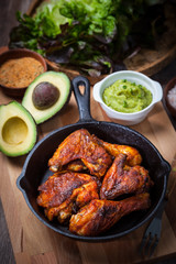 Grilled chicken legs and wings with guacamole