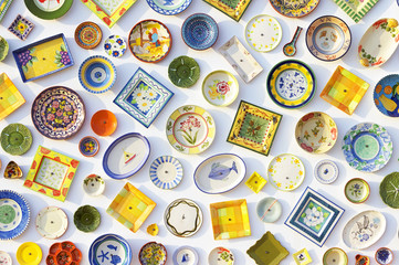 Colorful ceramic plates on the wall of the pottery store in Sagres, Portugal on June 07, 2015