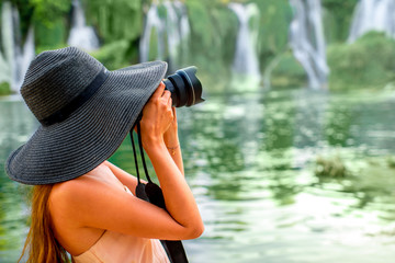 Fototapeta na wymiar Woman tourist near Kravica waterfall