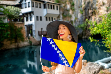 Woman with Bosnian flag in Blagaj village