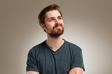 Portrait of young man with beard, think about