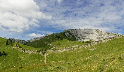 mountain with a blue sky and small clouds