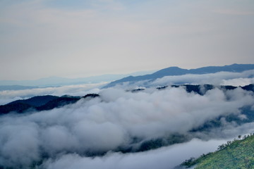 Clouds roll over the volcanic mountaintop during a rainy season 