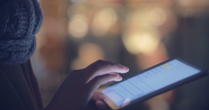 Woman chatting on touch pad outdoor in  the evening