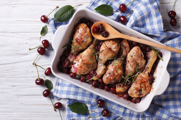 Baked chicken legs in cherry sauce close up. horizontal top view
