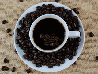 Cup of coffee on hemp sack