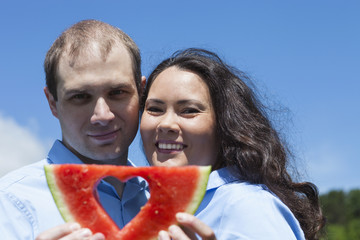 American  attractive couple with watermelon at summer