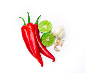 red chili , garlic and lime lemon arrange on white background