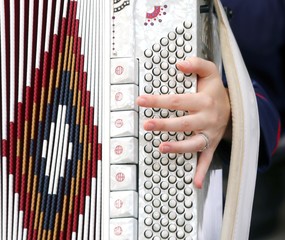 young woman plays the ancient accordion keyboard