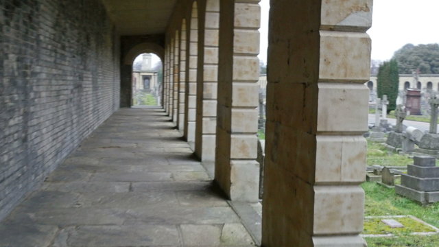 The hallway on a building inside the cemetery. Seen are the gravestones on the front of the building