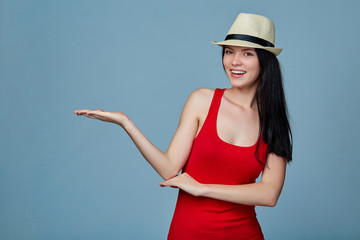 Young woman showing holding on the palm blank copy space over bl